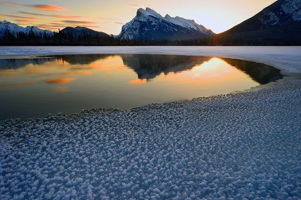 Snow crystals rim a lone break in the ice on Vermilion Lakes on a cold Banff National Park winter mo